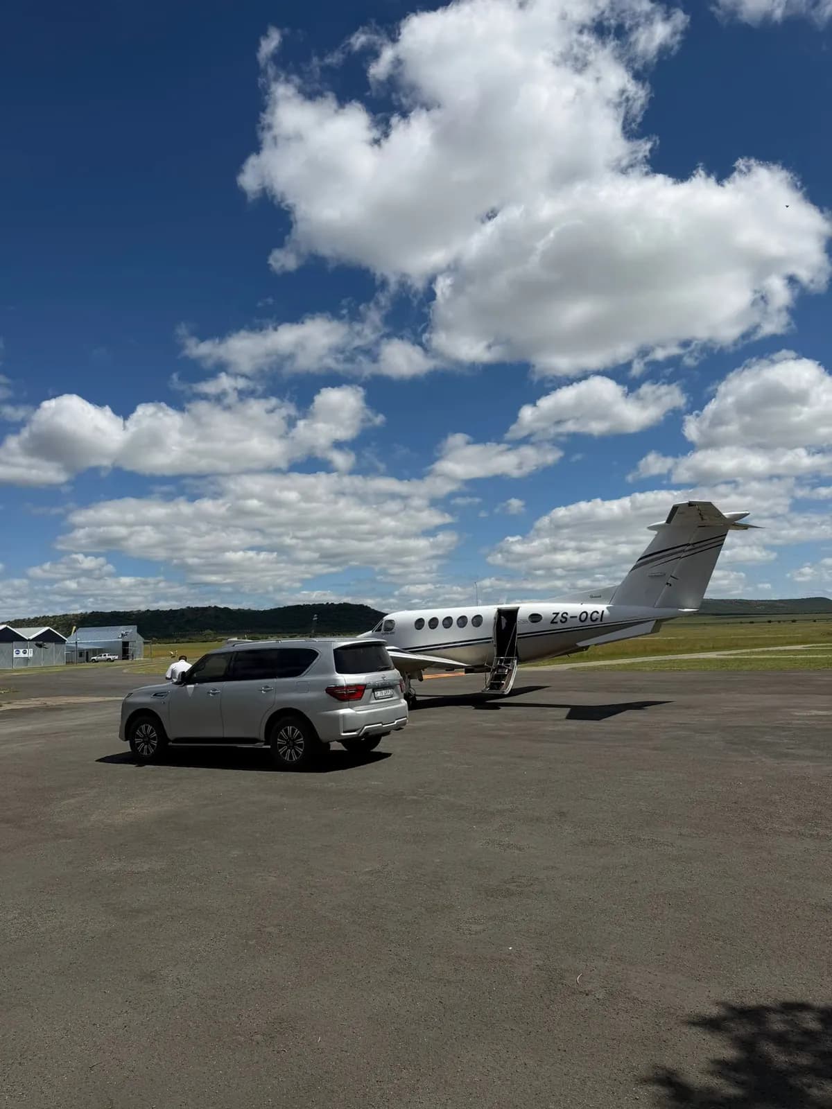Car parked beside a business jet