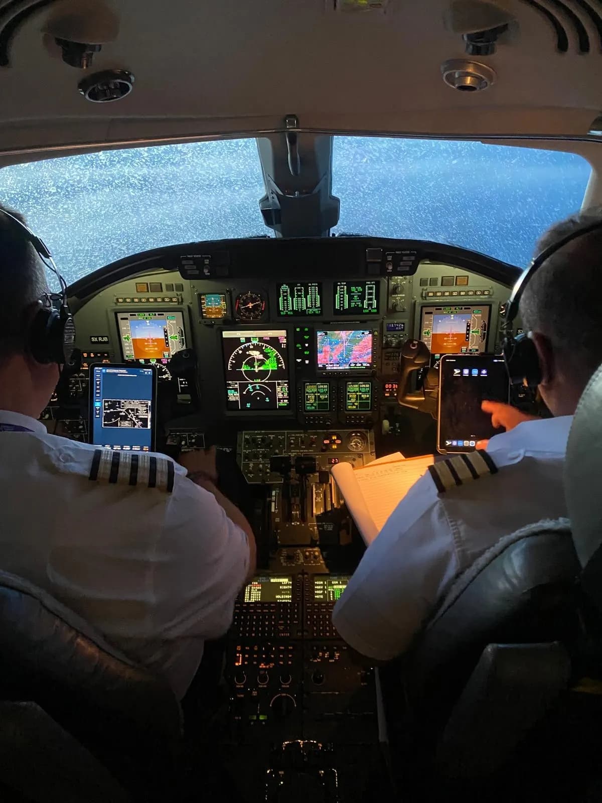 Flight crew at the controls, seen from the cabin