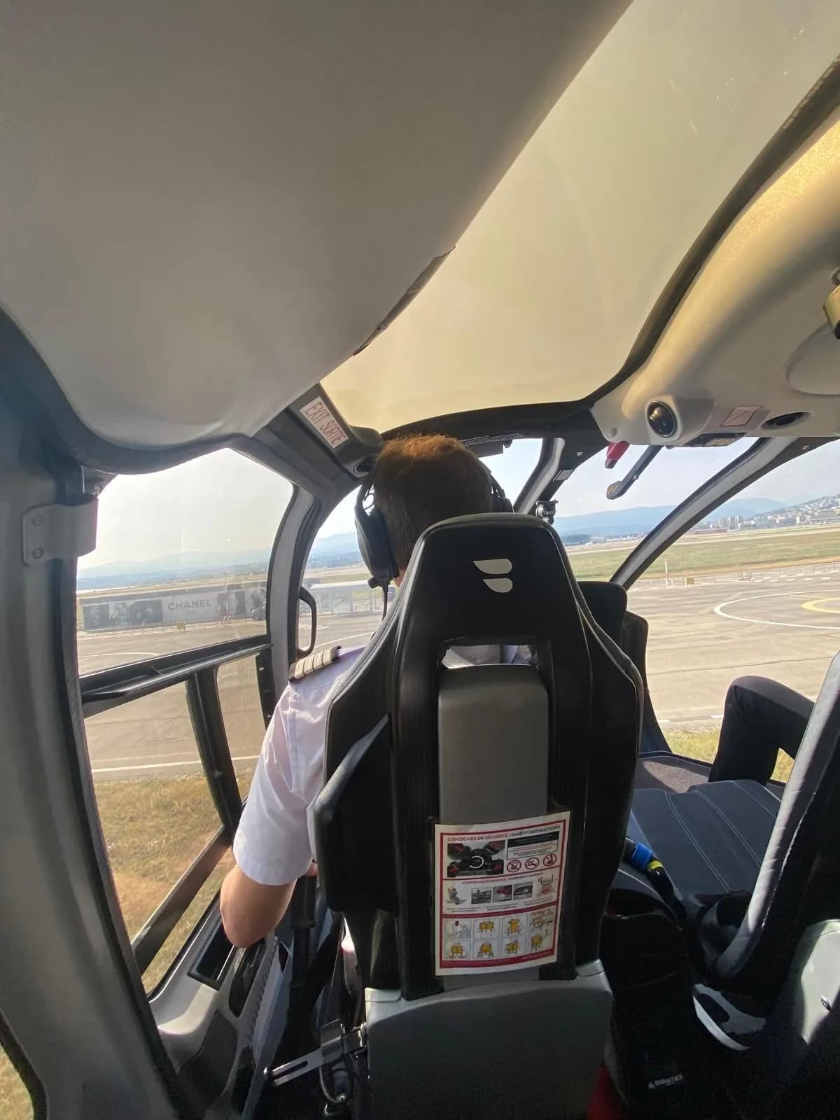 Pilot at the controls of a helicopter on the ground