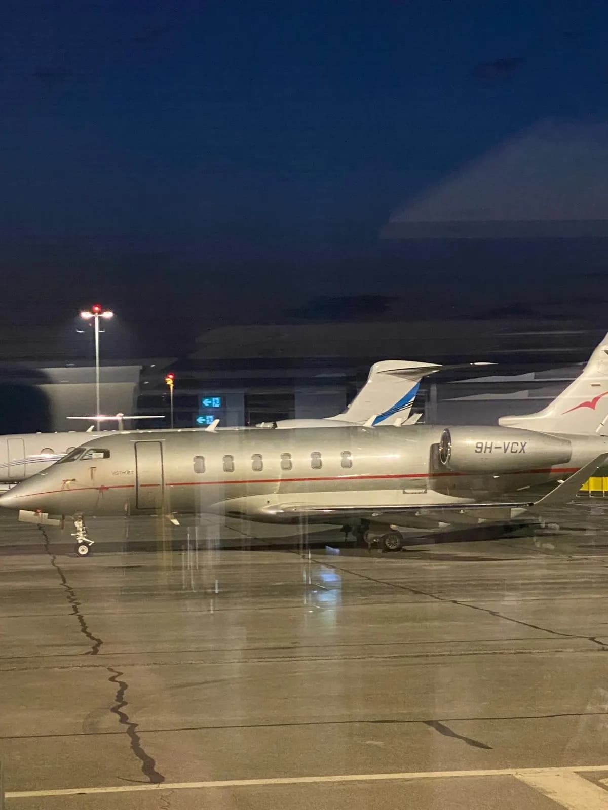 Business jets parked at night