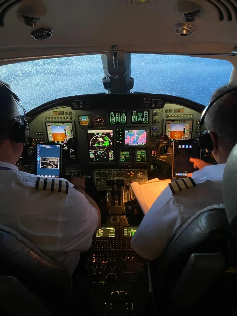 Flight crew at the controls, seen from the cabin