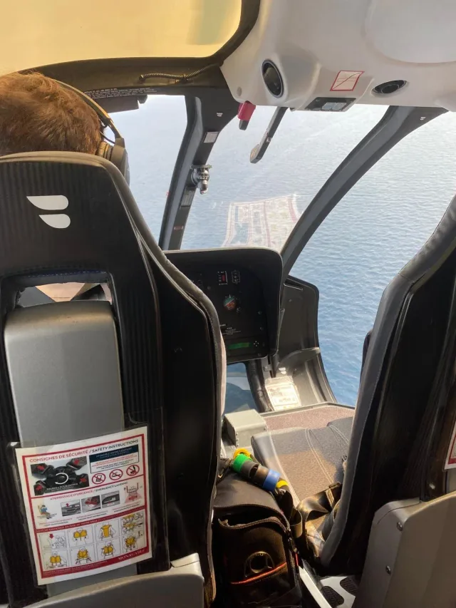 Helicopter pilot flying along the coast