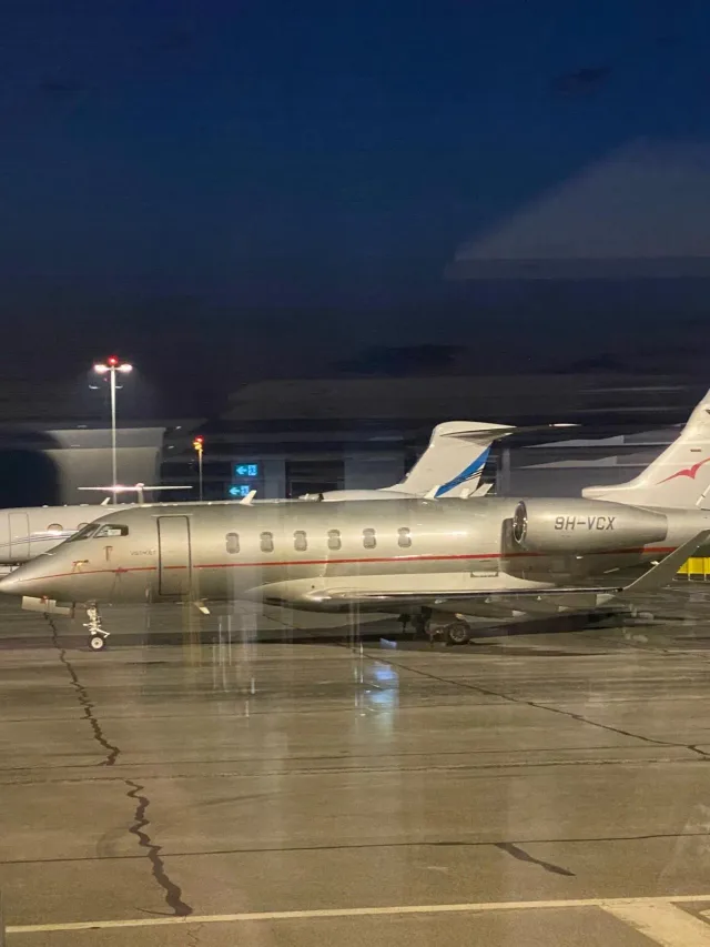 Business jets parked at night